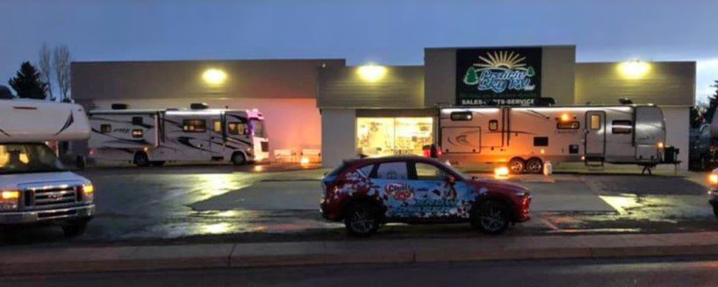 Exterior of Prairie Sky RV building at night. 