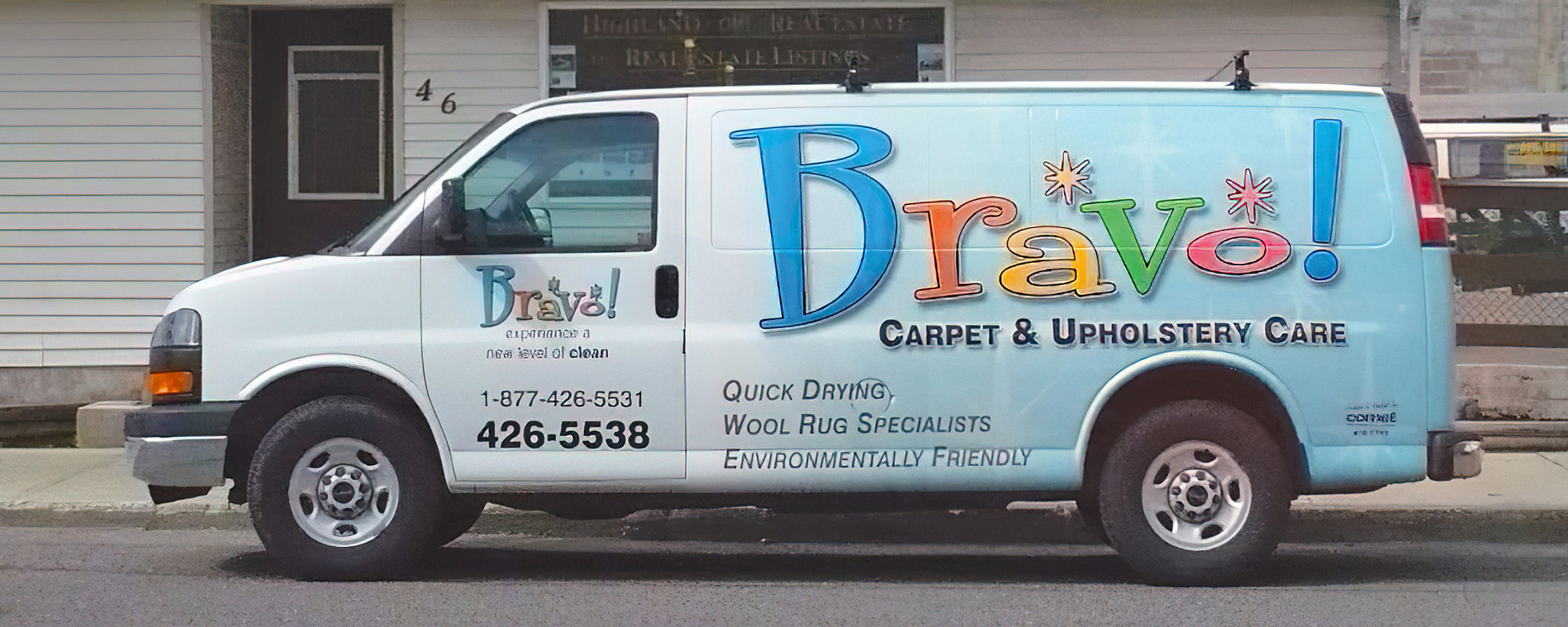 The Bravo Carpet & Upholstery Care white van with the multi-coloured company logo and contact phone number printed on the side 