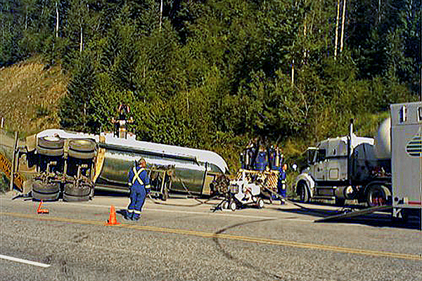 tanker truck rolled over on the side of the highway