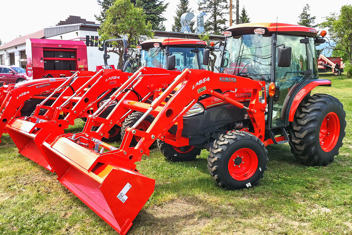 Red tractors parked outside 