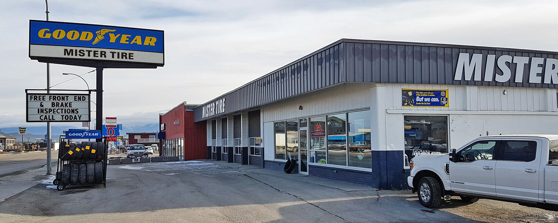 Exterior of Mister Tire shop in Cranbrook BC with vehicles pulled in for repair 