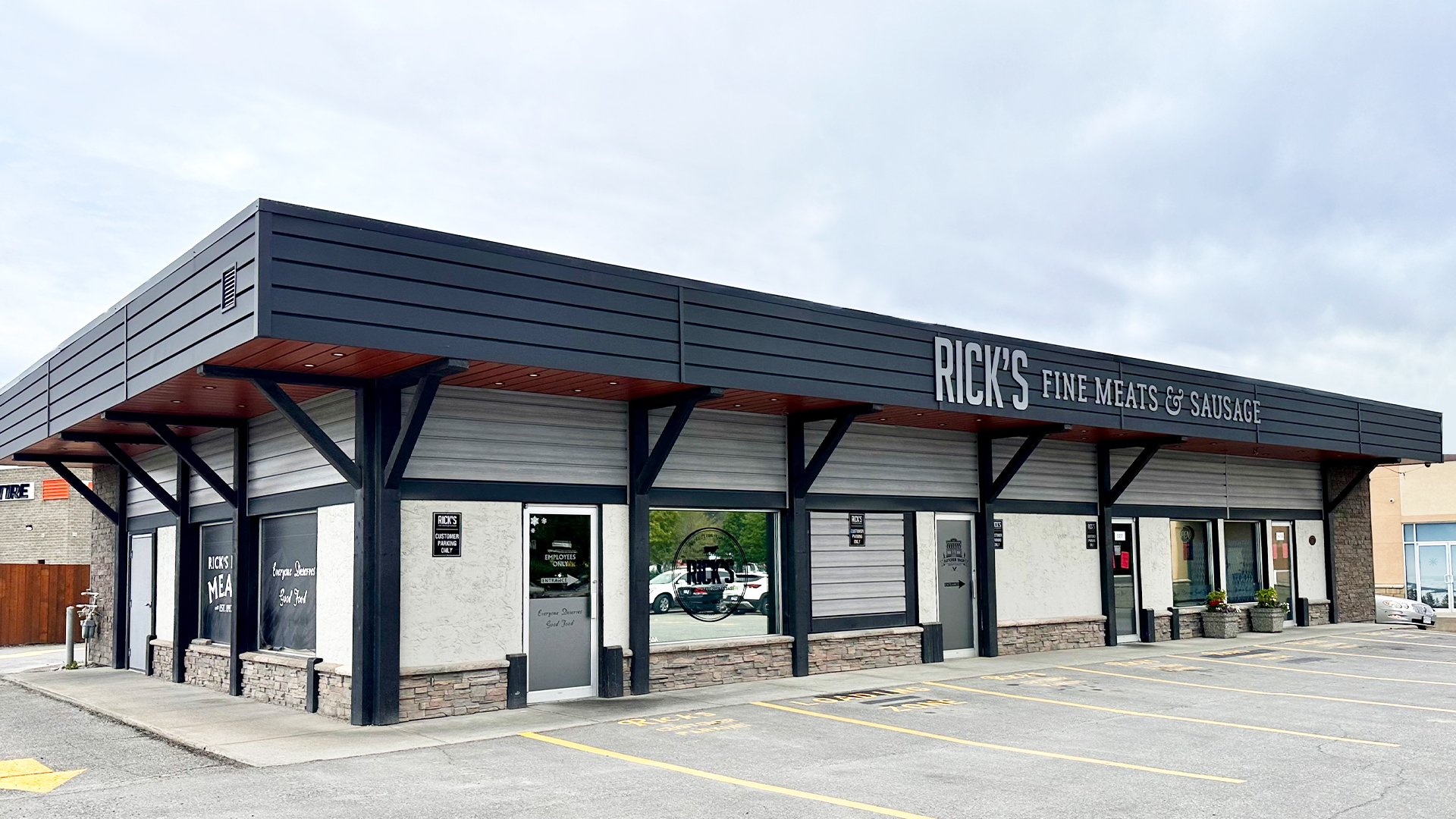 The exterior of the brown Rick’s Fine Meats building in Cranbrook, with the company name in white lettering above the entrance 