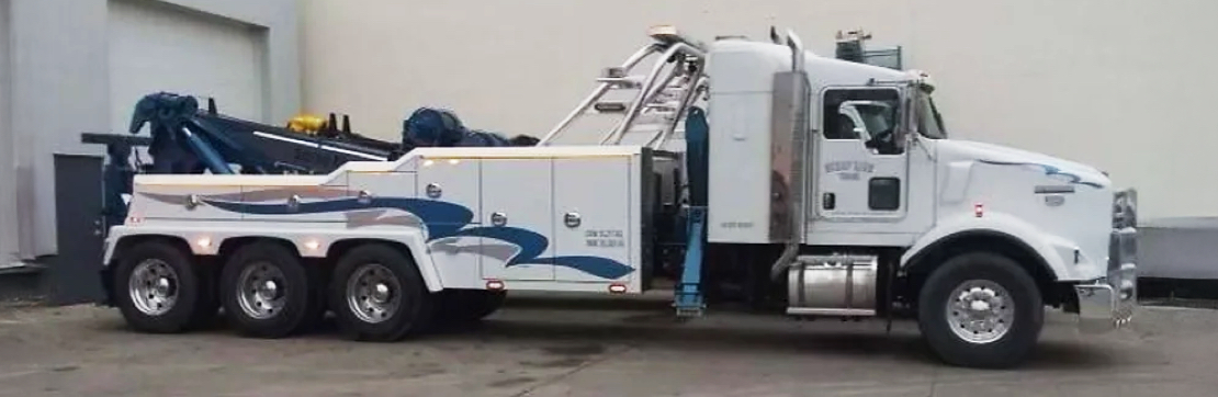 A white 50-ton tri-drive tow truck
