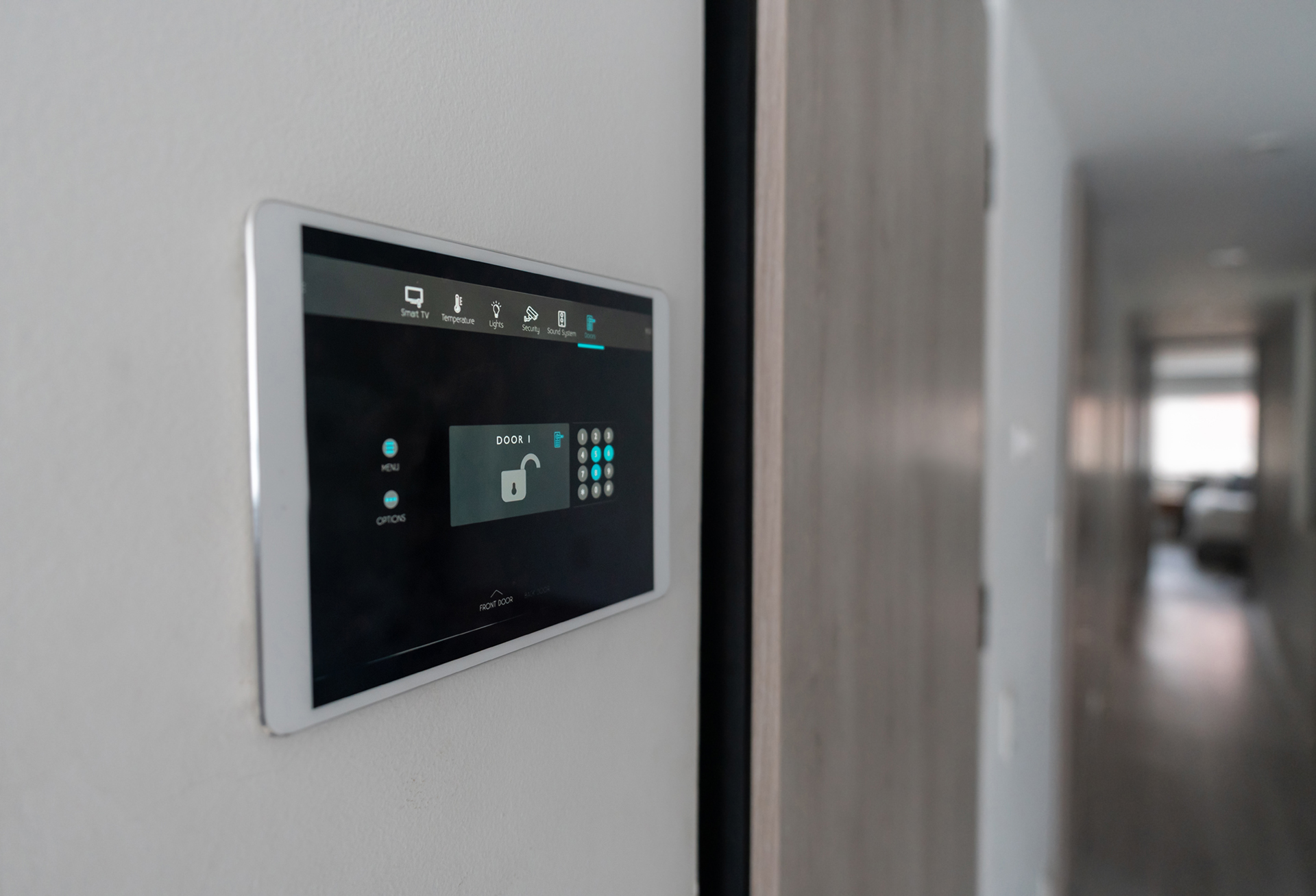 A black digital wall console that shows a keypad for an alarm system 
