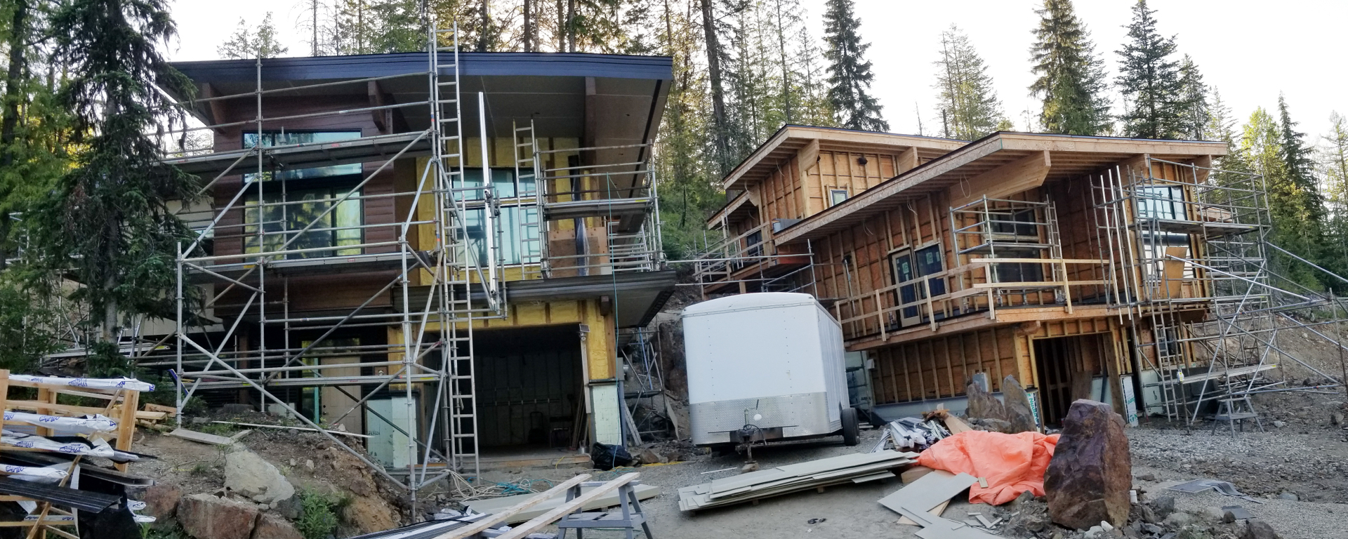 Exterior of a home that is being renovated, with ladders and building supplies out front 