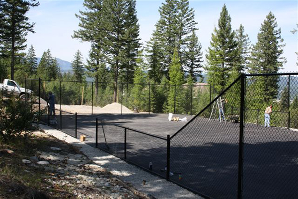 Metal fencing around an area paved with asphalt