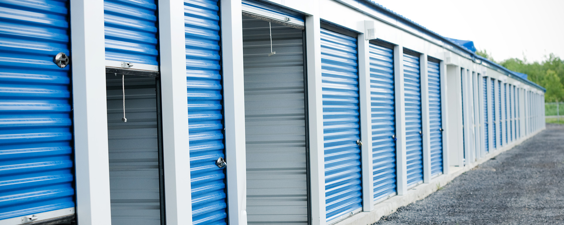 mini storage building with some doors open 