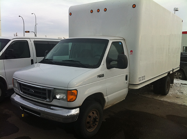Line up of white vehicles outside for rent