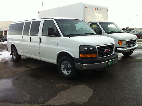 Line up of white vehicles outside for rent