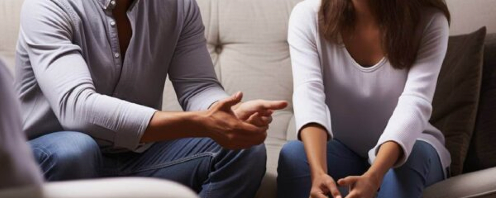 A man and a woman sitting together talking 