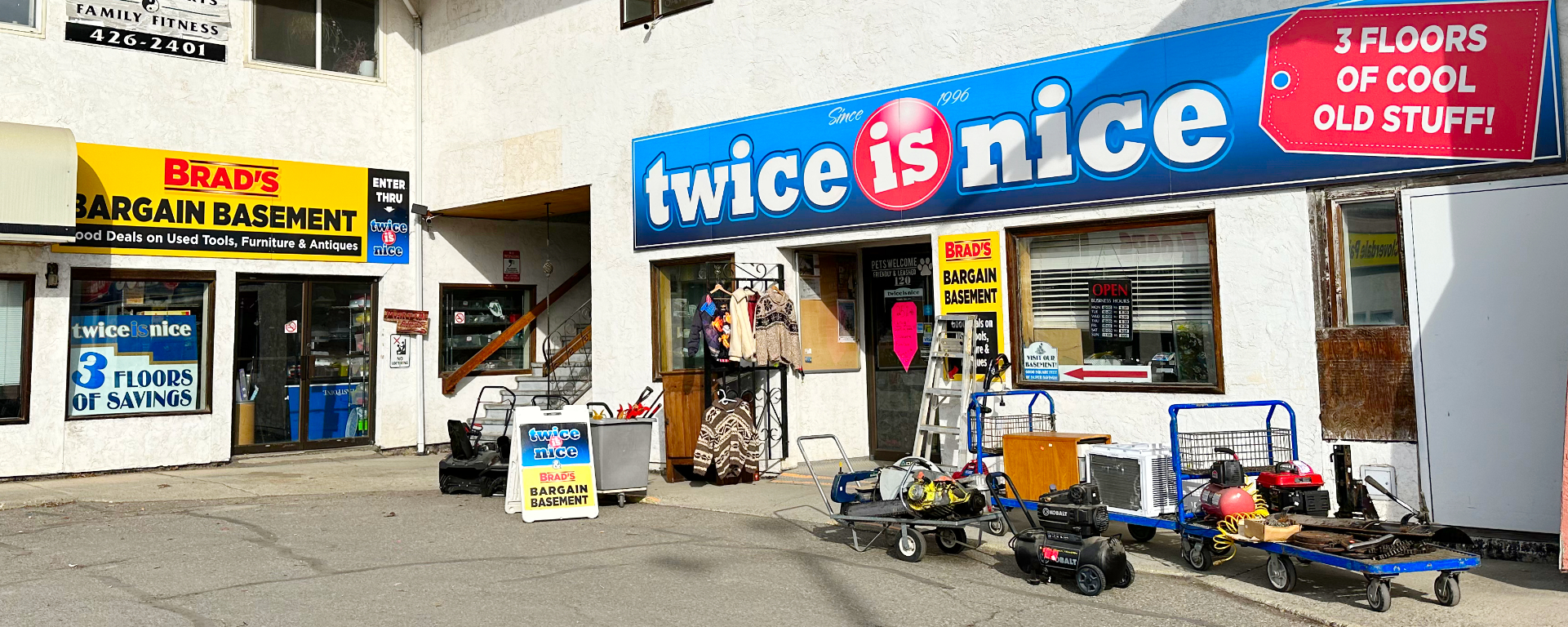 Storefront of Twice is Nice in Cranbrook, BC, featuring blue and yellow signage and various second-hand items for sale. 