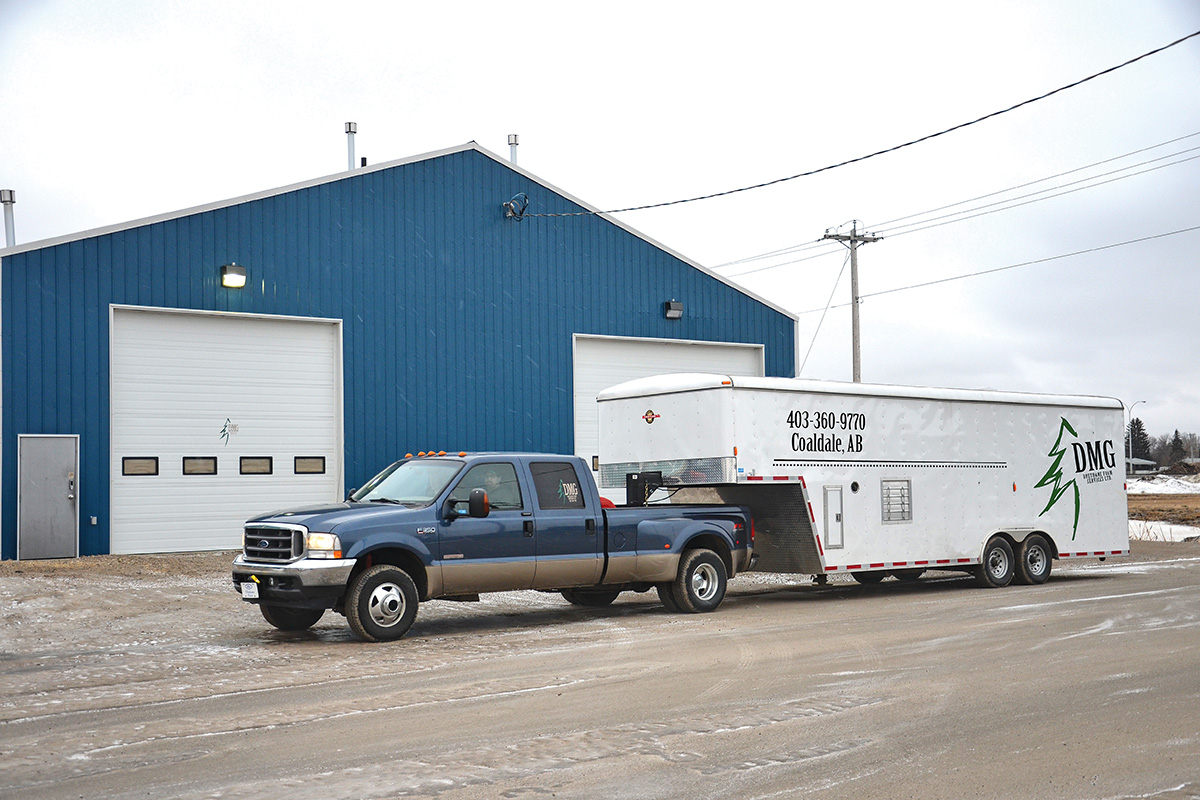truck hauling a trailer advertising D M G Urethane Foam Services