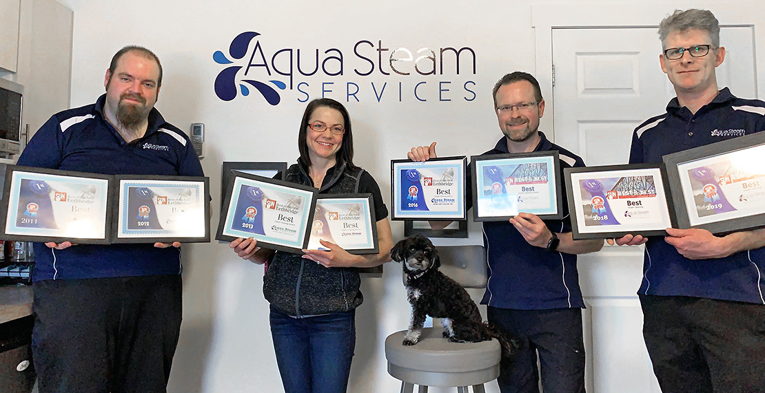 aqua steam staff holding awards 