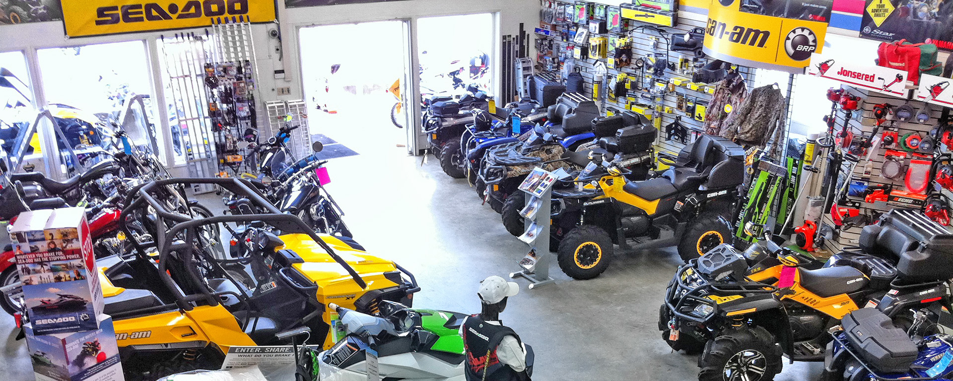 Showroom at Playmor Power products, showing a selection of snowmobiles and ATVs 