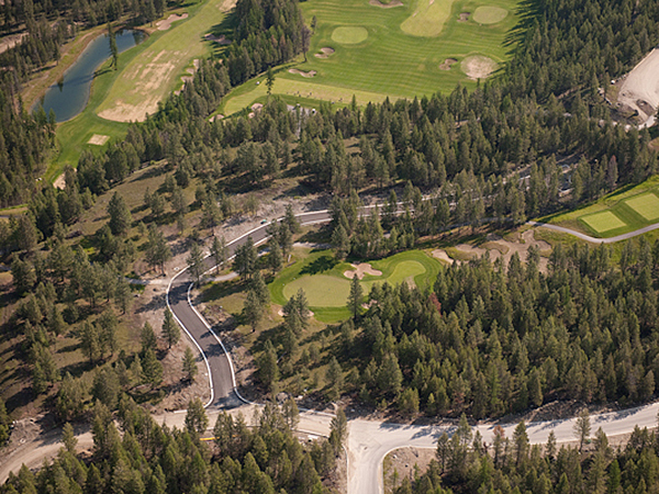 Aerial view of a paved road among a forested area