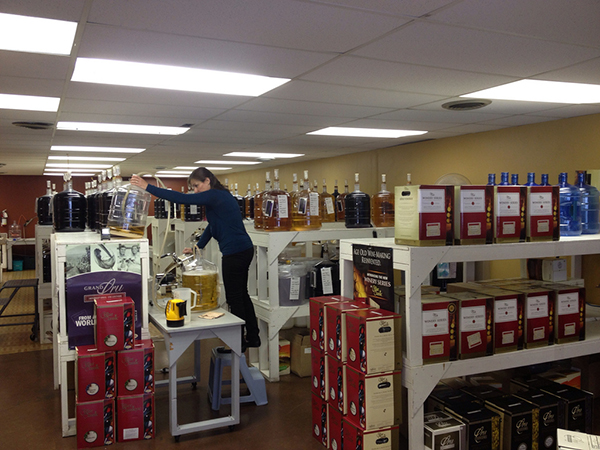 A woman stocking wine of shelves