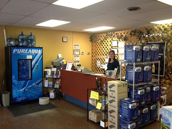 A woman at the front counter at Kootenay WineCrafters