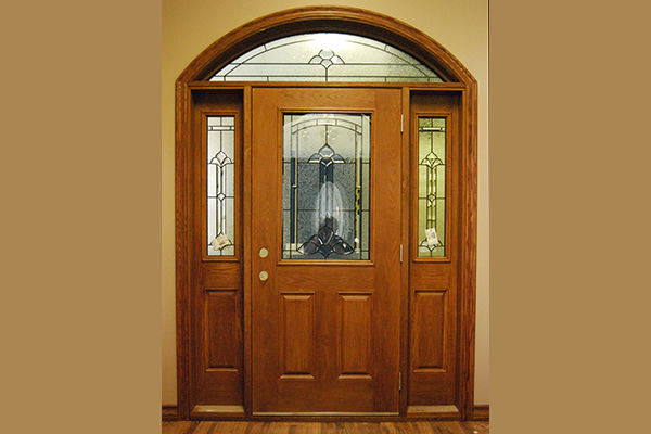 Maple coloured front door with specialty side lights