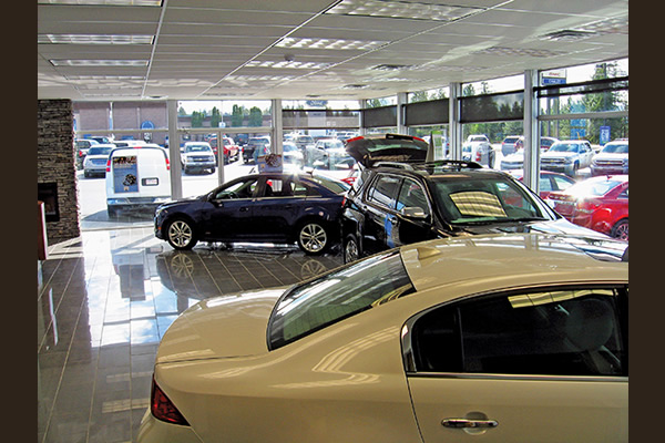 Cars parked inside showroom of dealership
