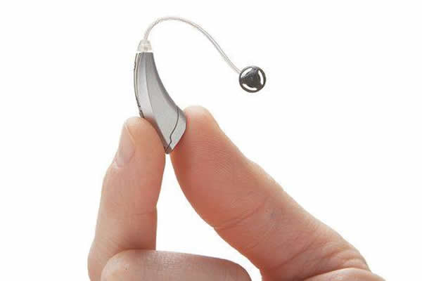 small silver coloured hearing device 