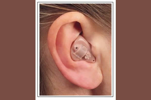 small hearing aid placed inside an ear 