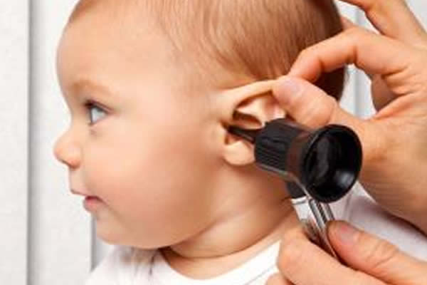 a baby getting her hearing checked 