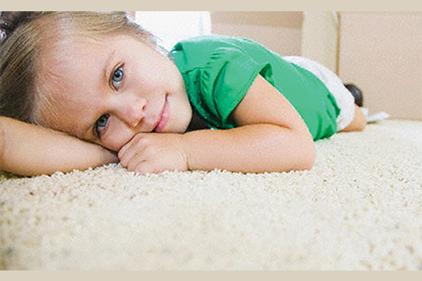 Little girl laying on carpet