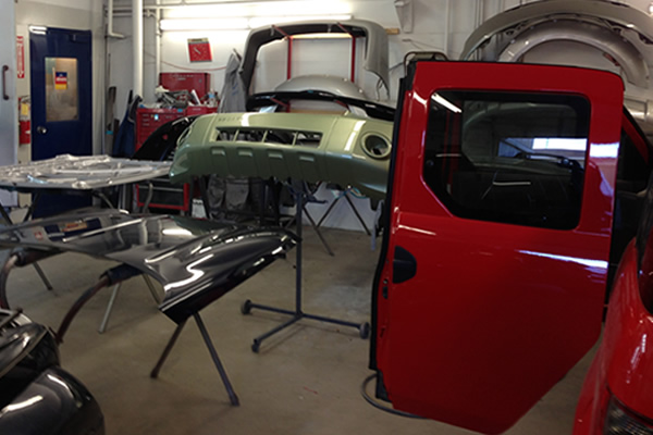 Vehicle parts in a shop being refinished and repainted