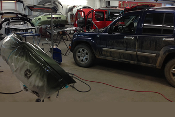Vehicles in the shop at Kustom Auto Body