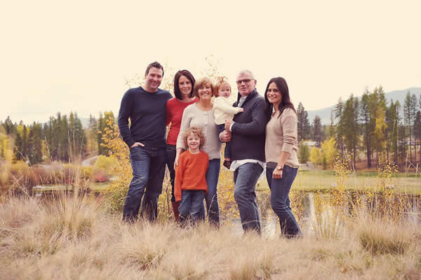 family photo outdoors by a body of water 