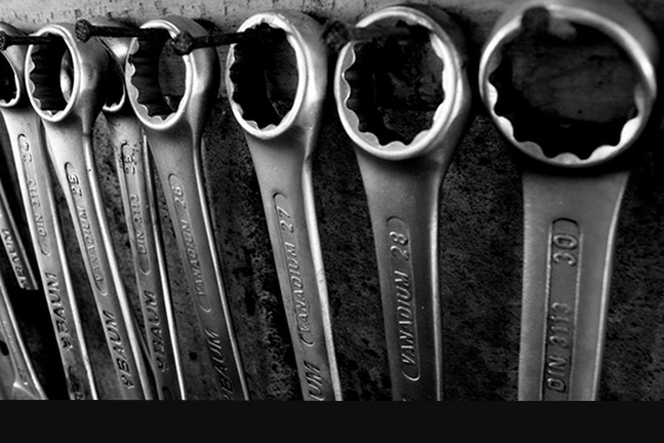 Wrenches stored on nails mounted on a wall