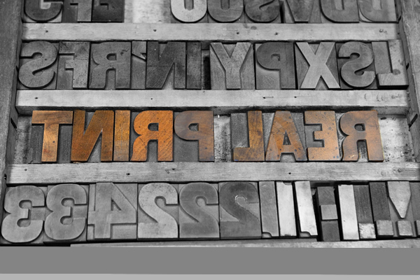 metal sign reading real print backwards