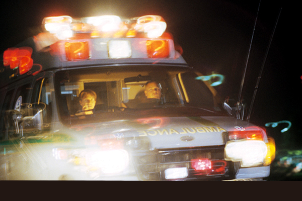 An ambulance driving with lights flashing
