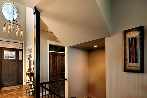 Open entrance of a show home with a chandelier