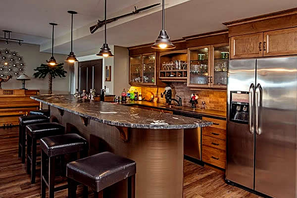 Warm tones in an open concept dining area with bar seats at an island