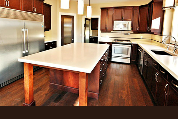 Interior of a kitchen displaying an island and stainless steel appliances