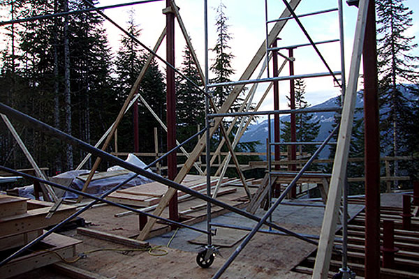 metal scaffolding set up outside with mountains in the background