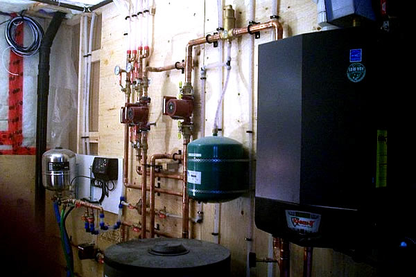Inside a mechanical room containing pipes and electrical box