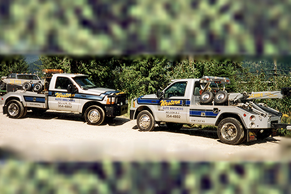 Two semi tow trucks advertising Western Auto Wreckers 