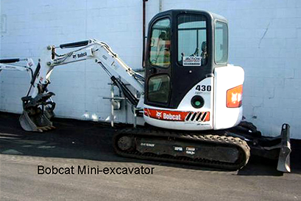 Bobcat parked outside of building