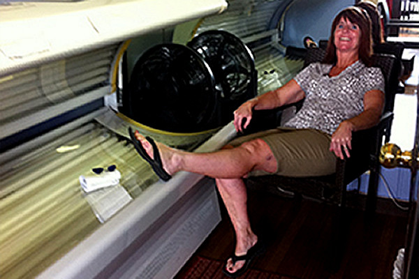 Seana Coolbaugh sitting next to a tanning bed