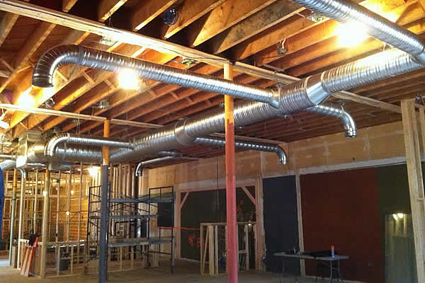 stainless steel pipes mounted in the roof of an industrial building