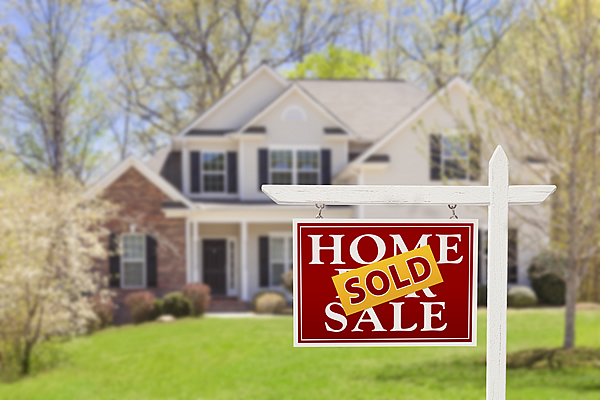country house in the background with a Home For Sale and Sold sign in the front property