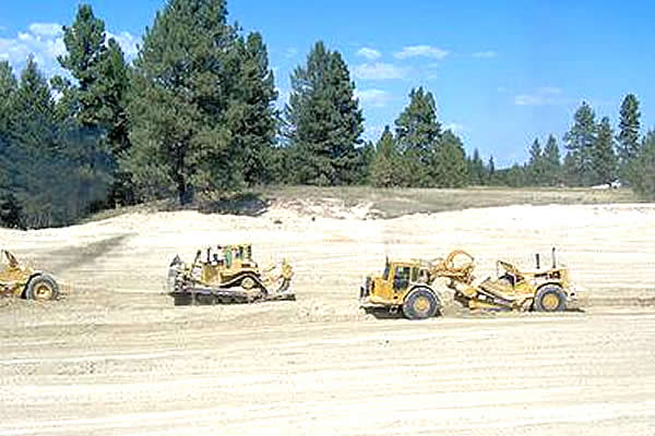 tractors and loaders excavating a new highway 