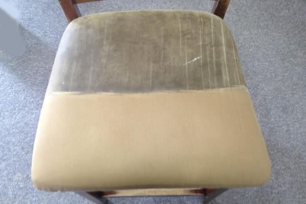 A chair cushion with half the seat being cleaned to show the difference 