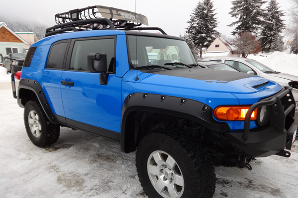 blue F J parked outside in the snow