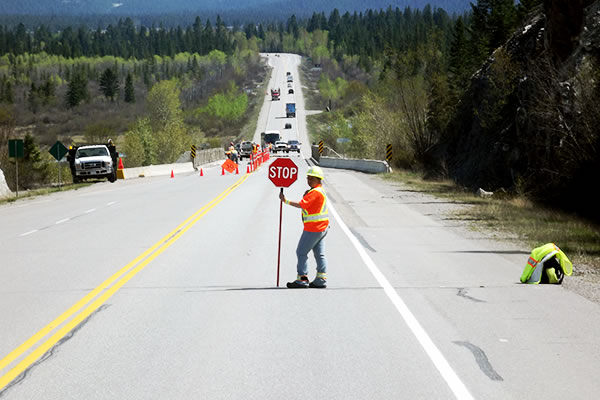 Flagger on highway holding a stop sign