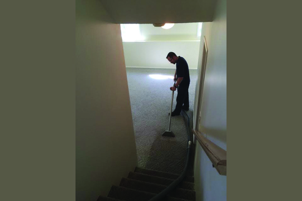 a man professionally cleaning a carpet 