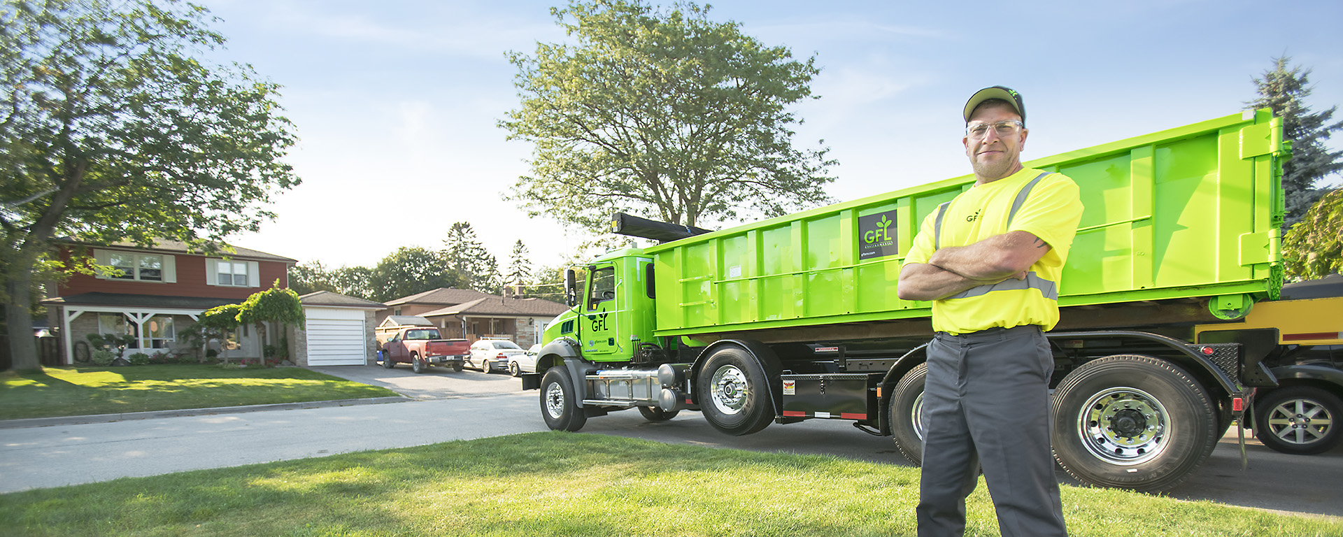 Man standing in front of a green GFL Environmental truck 