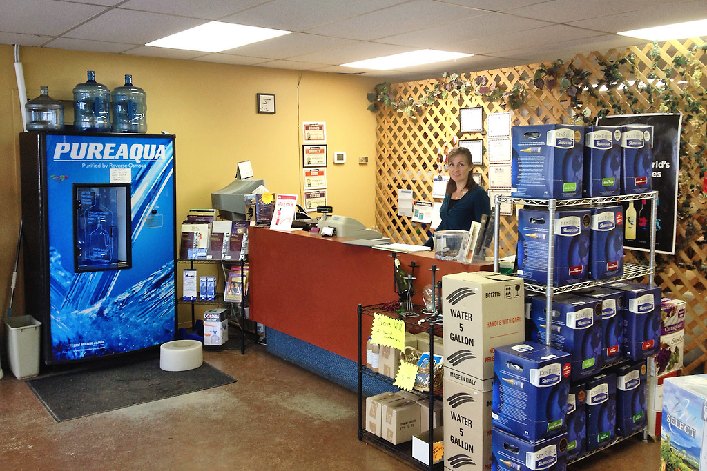 A woman at the front counter at Kootenay WineCrafters
